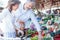 Happy smiling husband and wife shopping for groceries and fresh food in a marketplace