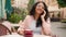 Happy smiling Indian Arabian ethnic woman girl visitor drinking cup coffee in city cafe morning outdoors female