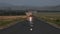 Happy smiling little boy child angel running with toy cardboard plane wings on rural road