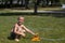 Happy smiling little boy play in water drops from irrigation hose