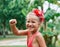 Happy smiling little girl portrait dancing on summer day in the street