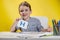 Happy smiling little preschool boy shows letters at home making homework at the morning before the school starts. English learning