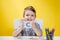 Happy smiling little preschool boy shows letters at home making homework at the morning before the school starts. English learning