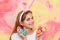 Happy smiling little teen girl with bunny ears holding painted easter eggs. Happy easter holidays concept. Cute girl