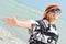 Happy smiling & looking at camera mature woman enjoying breeze on seashore