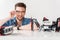 Happy smiling male technician squatting behind desk