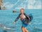 Happy smiling man with a board for Wakesurfing on beach after riding at sunset. Water skiing. A male athlete plays water sports