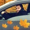 Happy smiling man driver behind the wheel of his car