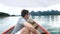 Happy Smiling Man Sitting on Wooden Boat and Sailing on Morning Blue Lake