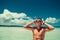 Happy smiling man in swimming goggles enjoying summer beach vacation. Time to travel. Stress free. Looking up sky. Shirtless fit a