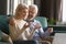 Happy smiling mature family, wife and husband using laptop together