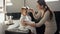 Happy smiling mother combing her baby son hair with hairbrush after washing in bath