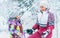 Happy smiling mother and daughter portrait in snow forest. Happy parents and kids relations concept image