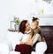 Happy smiling mother with little cute daughter at home interior, casual look modern real family, lifestyle people