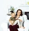 Happy smiling mother with little cute daughter at home interior, casual look modern real family, lifestyle people