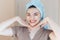 Happy smiling pretty beautiful woman girl with towel on head smiling touch healthy clean soft moisturized hydrated skin care after