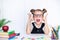 Happy smiling pupil at the desk. Child in the class room with pe