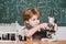 Happy smiling pupil drawing at the desk. schoolchild. It was a little chemistry experiment. Chemistry lesson. School