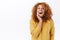Happy smiling redhead woman with curly hair, wear yellow sweater, laughing and touching face surprised and pleased, glad