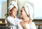 Happy, smiling and relaxed mother and daughter spa day at home with face masks for healthy skincare and personal hygiene