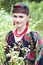 Happy smiling Russian woman sitting in the field