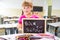 Happy smiling schoolchild holding small blackboard