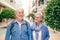 Happy smiling senior couple of tourist walking in the city. Attractive white haired caucasian people