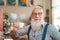 Happy smiling senior man drinking coffee in bar restaurant - Hipster trendy older male portrait