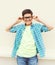 Happy smiling smart teenager boy in glasses wearing a checkered shirt