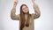 Happy smiling teenage girl dancing and celebrating success or victory over white studio background