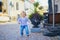 Happy smiling toddler walking in the street of Finnish town Porvoo