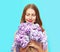 Happy smiling woman enjoying smell of bouquet lilac flowers