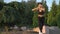 Happy smiling woman exercising in the park in the morning, slow motion