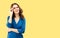 Happy smiling woman looking up, in eye glasses, confident wear, yellow background. Business success. Copy space