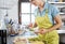 Happy smiling woman preparing sandwich