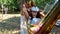 happy smiling woman wearing virtual reality glasses rests in a hammock near a tree, imagining a dream come true, an