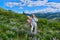 Happy smiling women hiking in meadows among wildflowers.