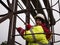 Happy smiling worker in helmet. industrial climber in uniform climbing stairs