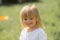 Happy smiling young baby caucasian blonde real people girl close outdoor portrait