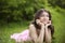 Happy smiling young bride girl dreaming on green grass at spring