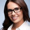 Happy smiling young brunette businesswoman in glasses, confident white clothing, over grey color background