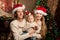 Happy smiling young family near the Christmas tree