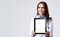 Happy smiling young female doctor showing tablet pc , grey background. Copy space. Medical care