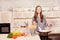 Happy smiling young woman cook in the kitchen