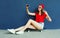 Happy smiling young woman taking selfie picture by smartphone sitting on skateboard wearing red baseball cap, shorts on city