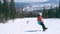 Happy snowboarder having fun snowboarding backcountry on a sunny winter day in snowy mountains. guy in a bright color