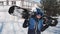 Happy snowboarder lifting snowboard over his head and placing it behind his back