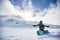 Happy Snowboarder on snowy day at winter mountains