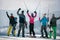 Happy snowboarders enjoy the snow-white scenery of mountains and