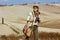 Happy solo traveller woman with binoculars in Tuscany ,Italy